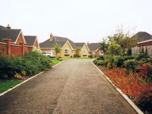 Gravel-surfaced estate road between bungalows